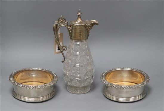 A plated glass claret jug and a pair of silver plated wine coasters